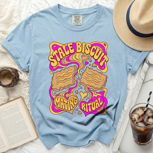Blue t-shirt with "Stale Biscuit Mating Ritual" graphic in wavy yellow and pink.