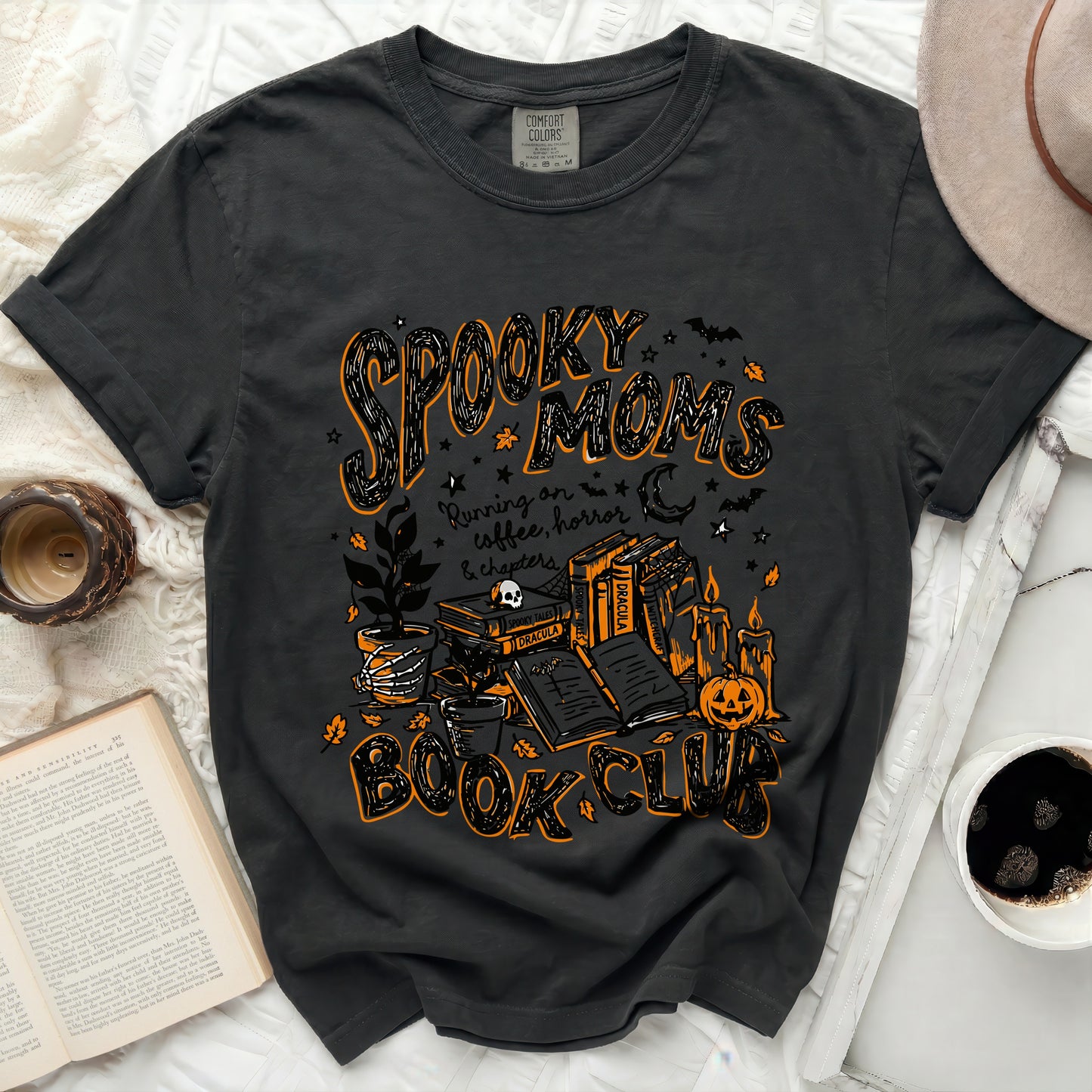 Black t-shirt with "Spooky Moms" and Halloween book club graphic.