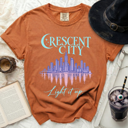 Orange t-shirt with "CRESCENT CITY" and "Light it up" text.