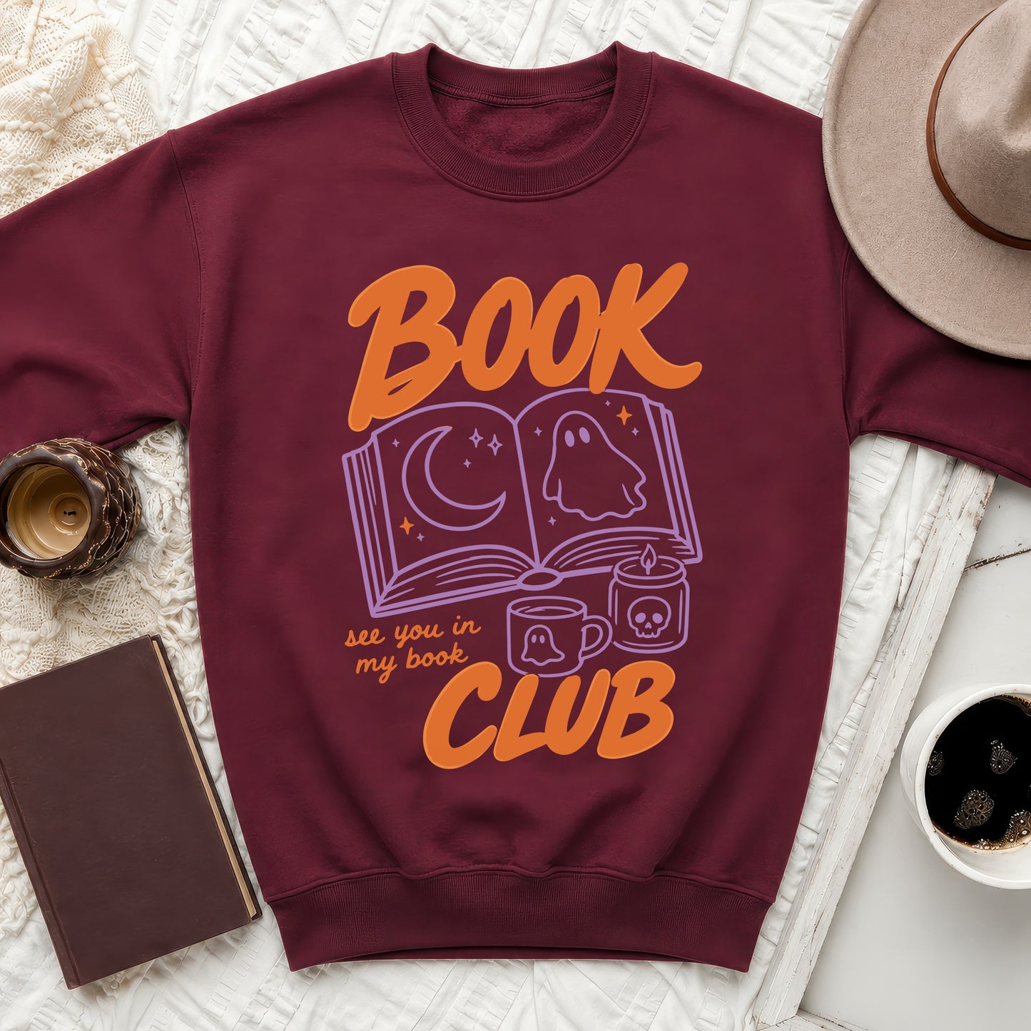 Maroon sweatshirt with "Book Club" and Halloween-themed book graphic.