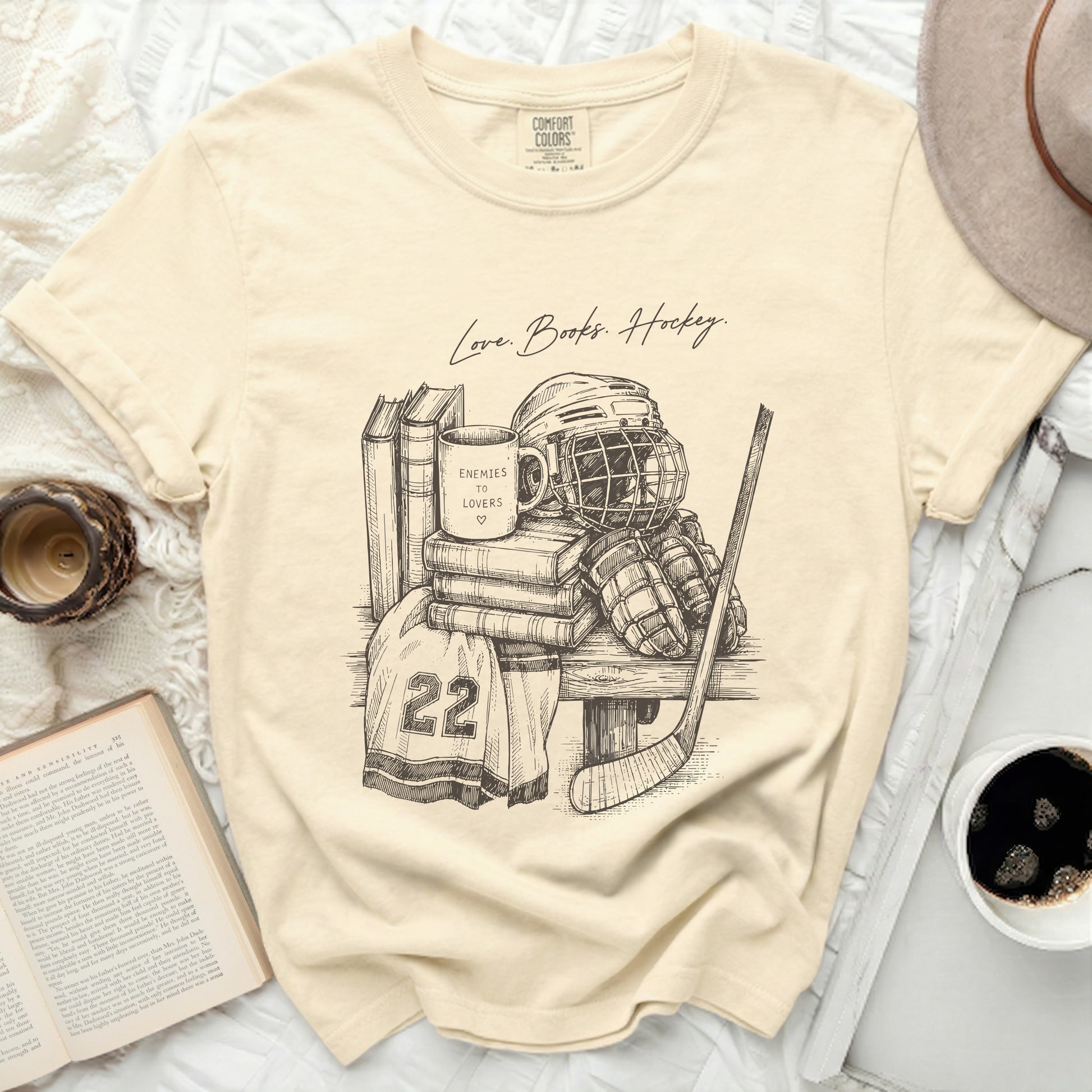 T-shirt with "Love. Books. Hockey." and hockey gear illustration.