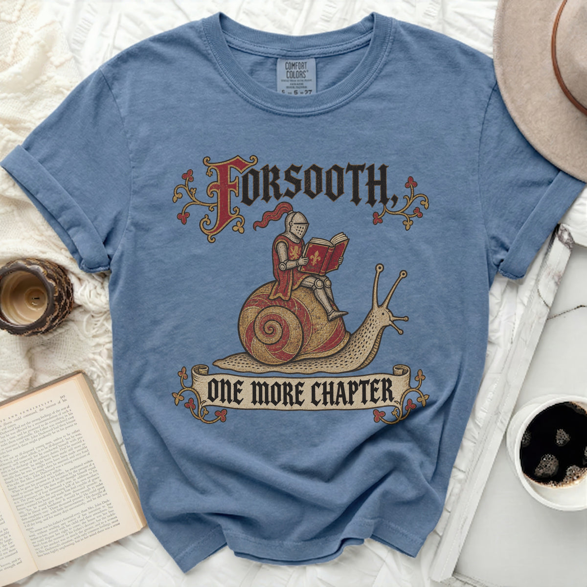 Blue t-shirt with "Forsooth, One More Chapter" text and knight on snail graphic.