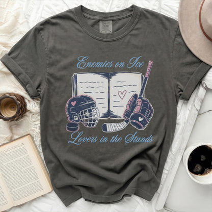 Dark gray t-shirt with "Enemies on Ice Lovers in the Stands" text and hockey graphics.