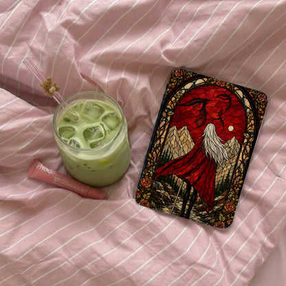A glass of iced matcha next to a tarot card with a red dragon and a cloaked figure.