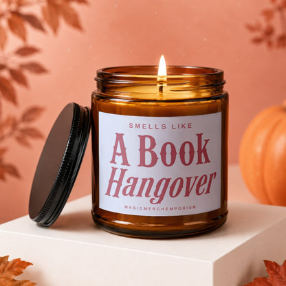 Amber jar candle with lit flame, labeled "A Book Hangover".