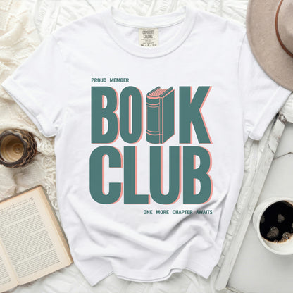 White t-shirt with "Proud Member Book Club One More Chapter Awaits" graphic.
