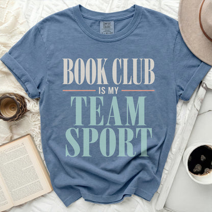 Blue t-shirt with "BOOK CLUB IS MY TEAM SPORT" text in white and green.