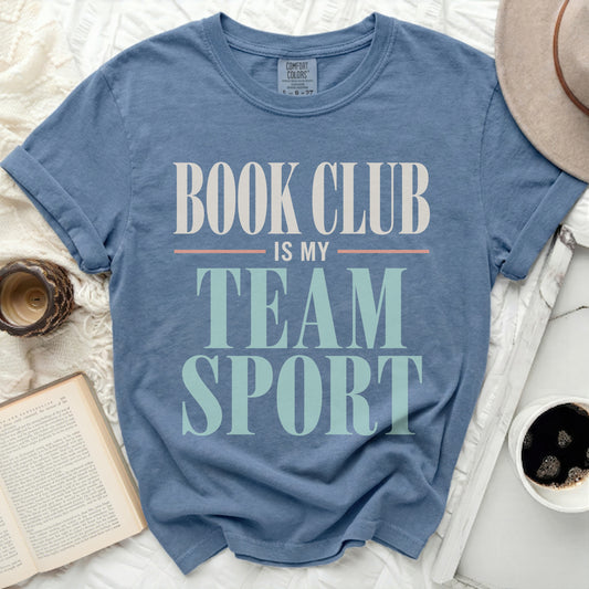 Blue t-shirt with "BOOK CLUB IS MY TEAM SPORT" text in white and green.