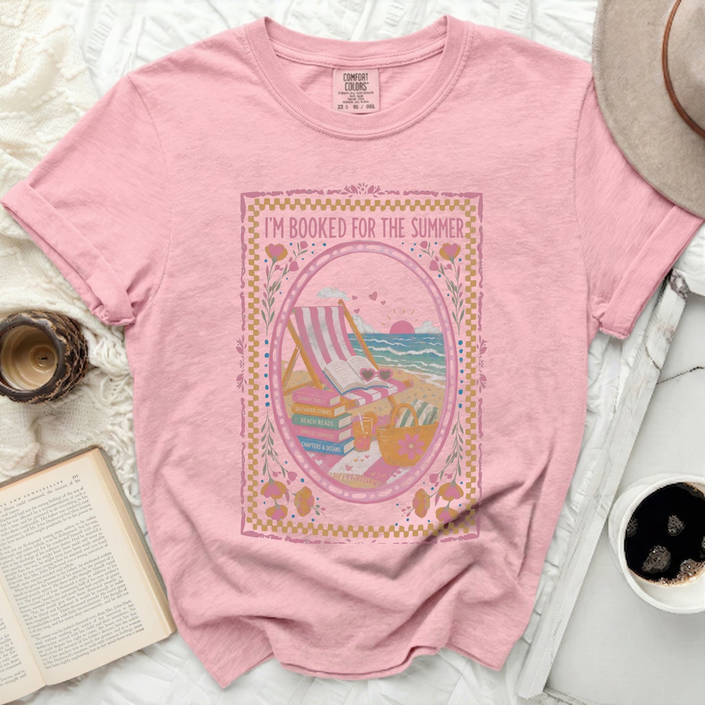Pink t-shirt with "I'm Booked For The Summer" graphic featuring beach scene.