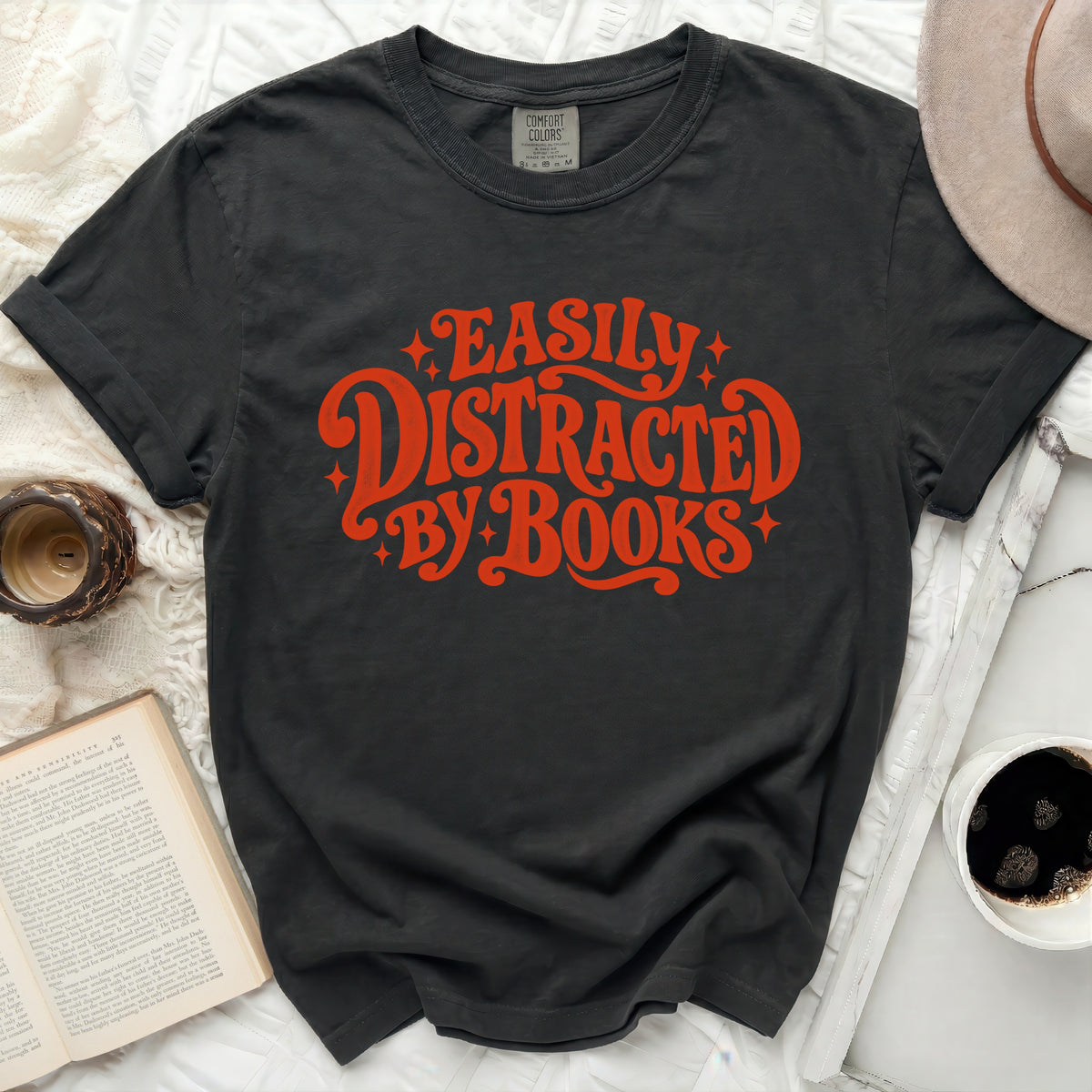 Dark grey t-shirt with "Easily Distracted by Books" graphic in red.