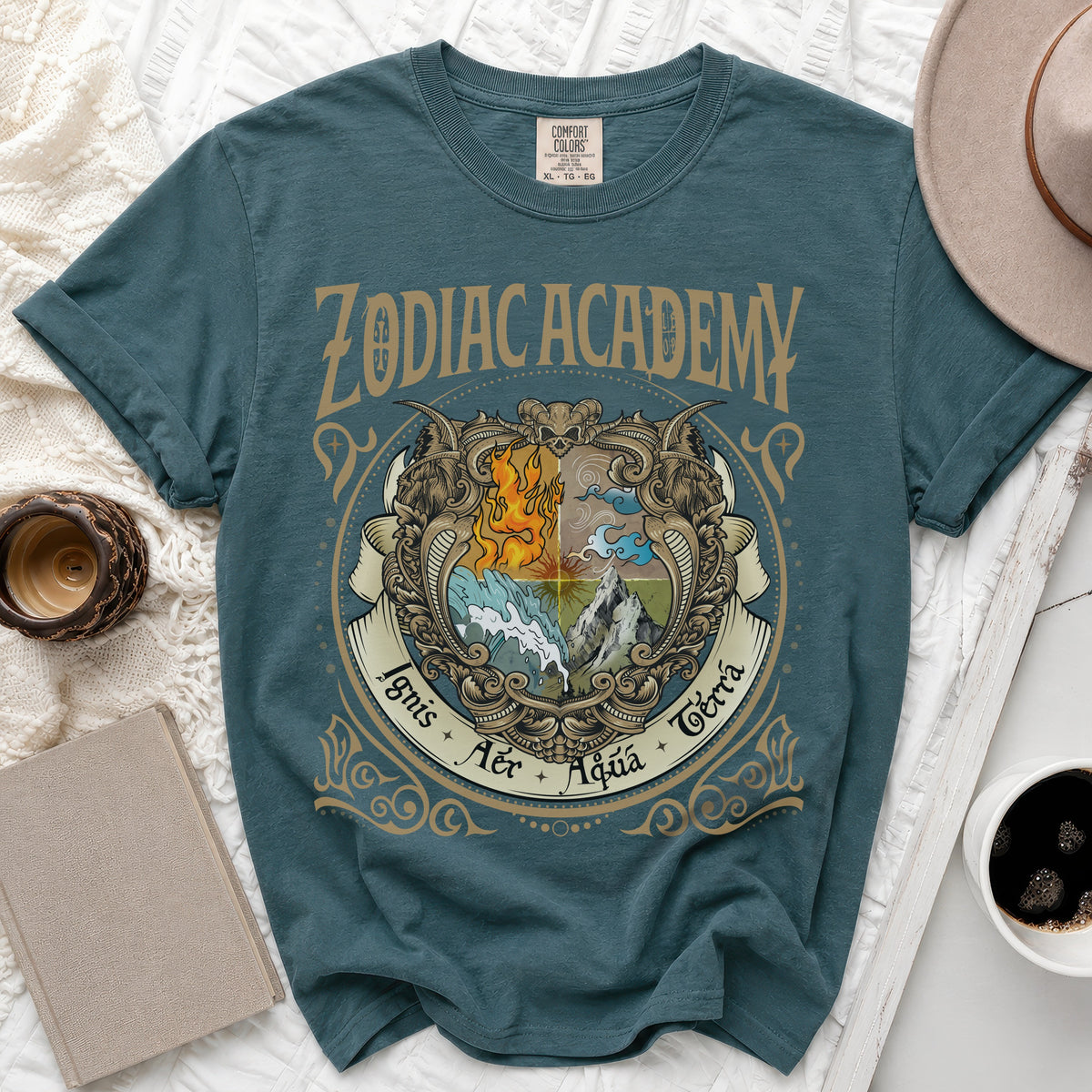 Teal t-shirt with Zodiac Academy crest featuring elements of fire, water, air, and earth.