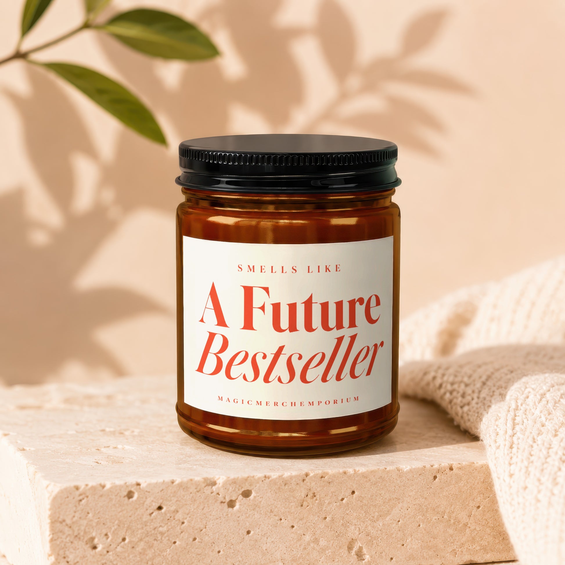 Amber candle in jar labeled "Smells Like A Future Bestseller" by MagicMerchEmporium.
