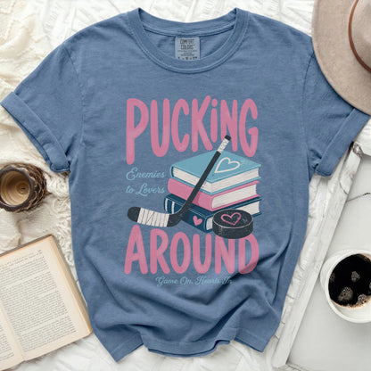 Blue t-shirt with "Pucking Around Enemies to Lovers" and hockey puck.