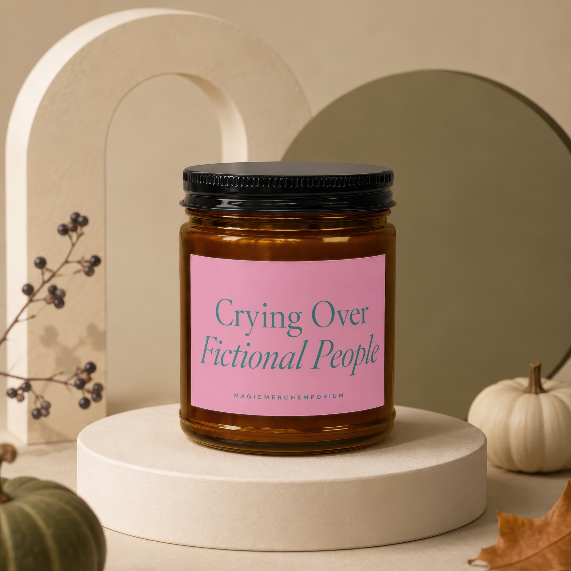 Glass candle with black lid and pink label reading "Crying Over Fictional People".