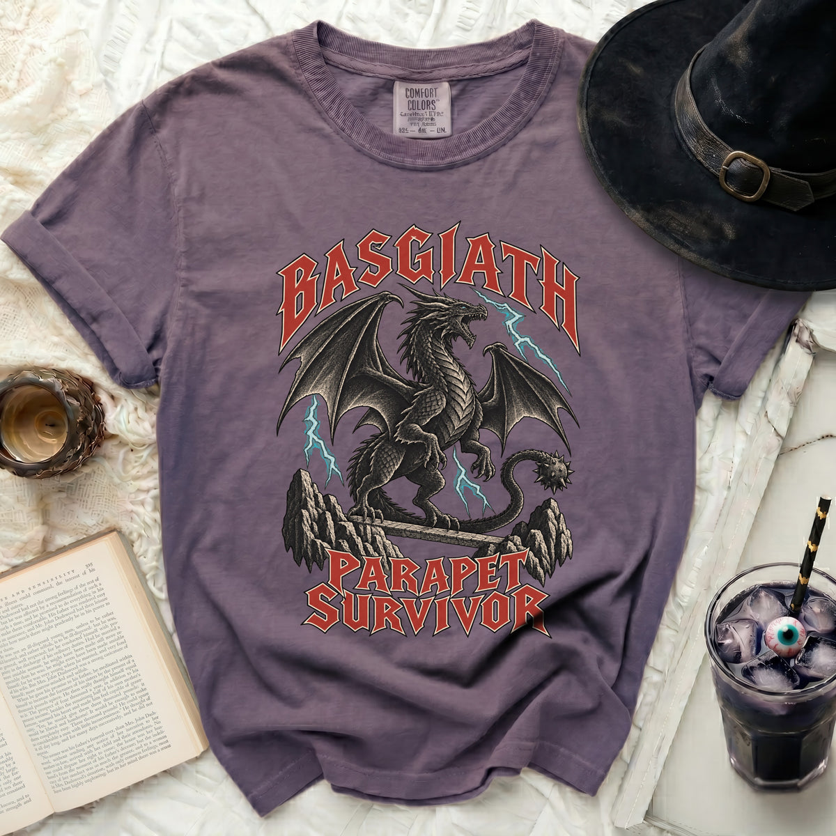 Purple t-shirt with a black dragon graphic and text "BASGIATH PARAPET SURVIVOR".