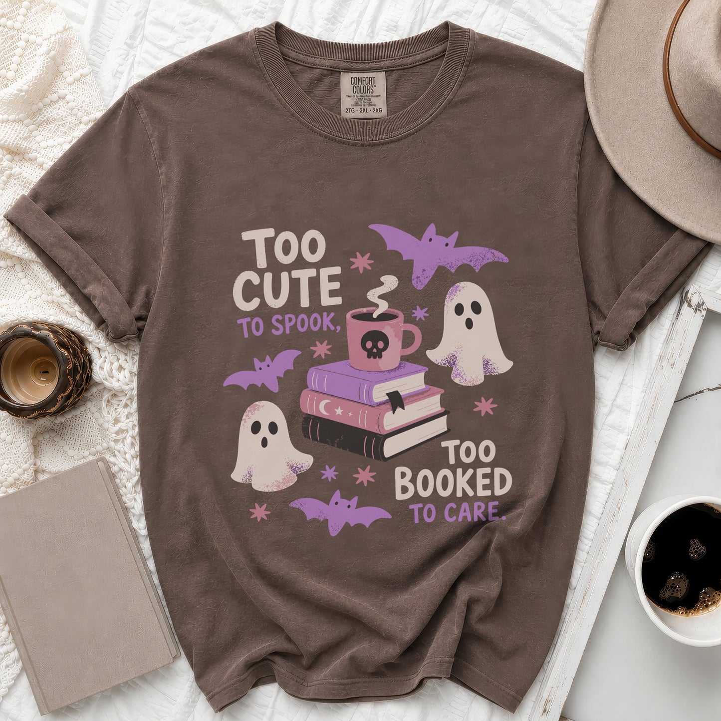 Brown t-shirt with "Too Cute to Spook, Too Booked to Care" slogan and Halloween graphics.