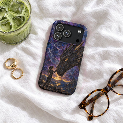 Phone case with a dragon design lying on a white cloth near glasses, rings, and iced drink.