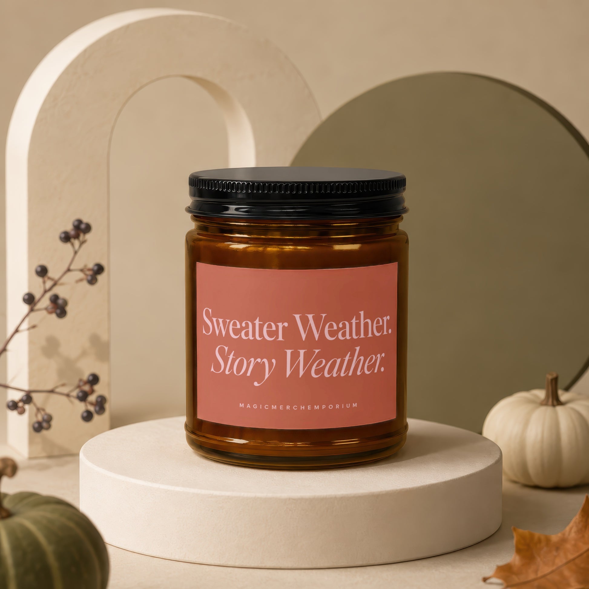 Candle with "Sweater Weather. Story Weather." text on a coral label.