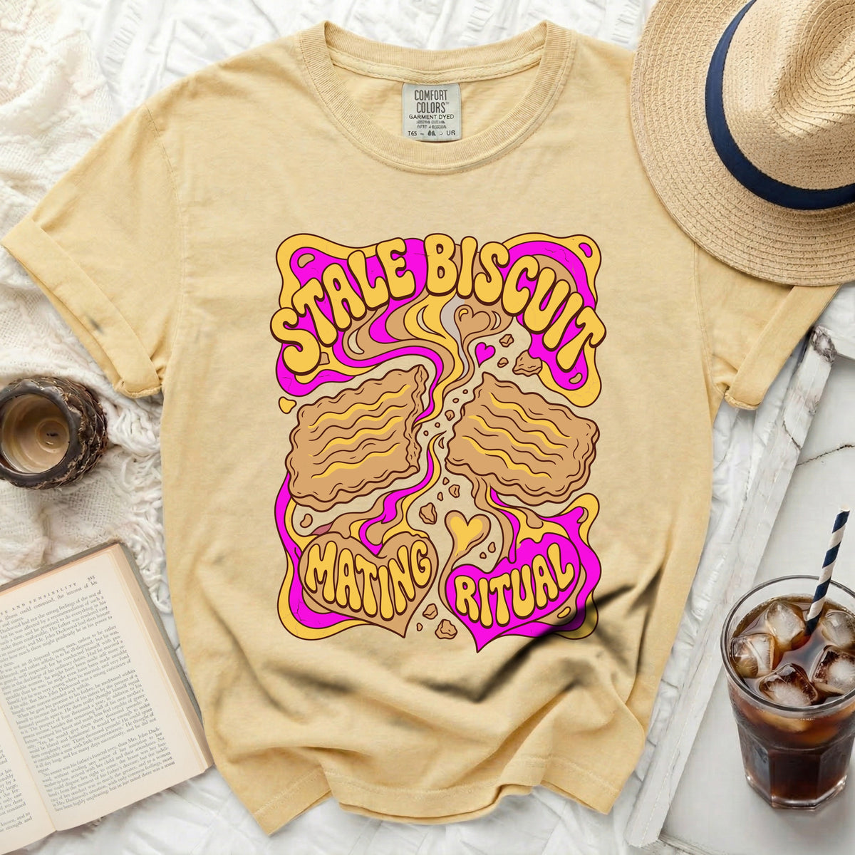 Yellow t-shirt with "Stale Biscuit Mating Ritual" graphic in pink and yellow.