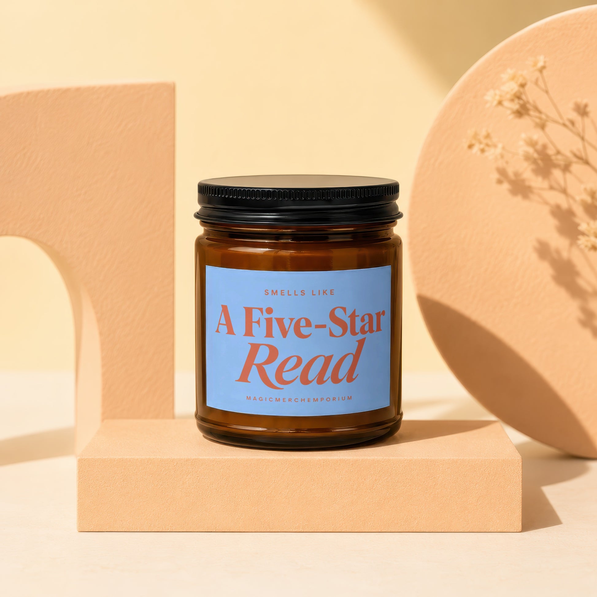Brown candle labeled "A Five-Star Read" by MagicMerchEmporium, displayed on a beige pedestal.