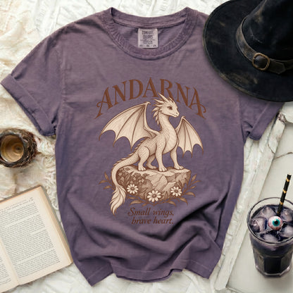 Purple t-shirt with "Andarna" and a dragon graphic, text "Small wings, brave heart."