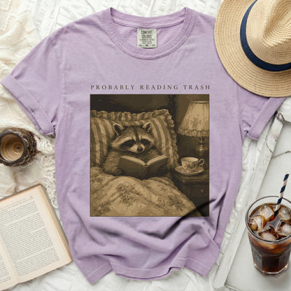 Purple t-shirt with raccoon reading "Probably Reading Trash" graphic.