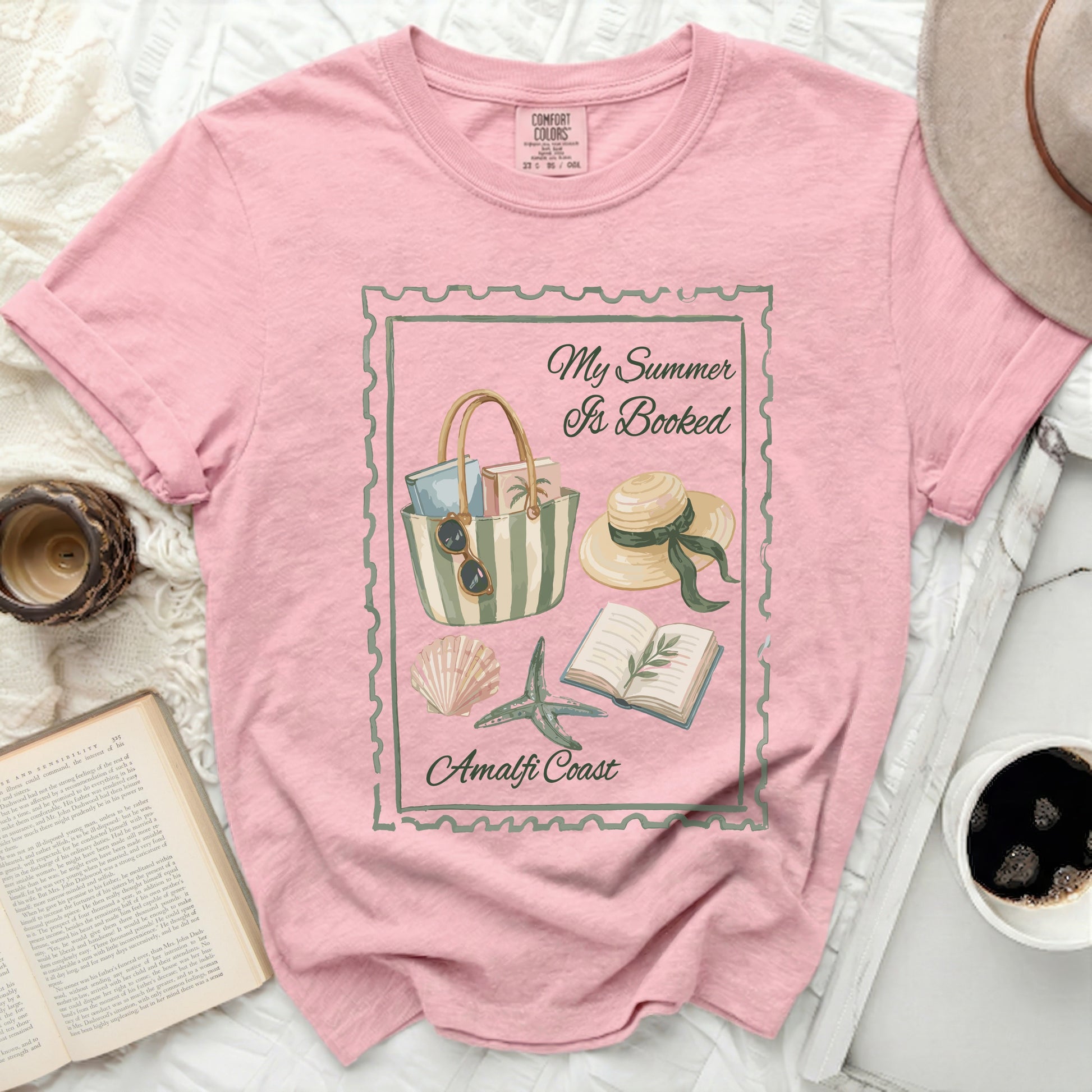Pink graphic tee with "My Summer Is Booked Amalfi Coast" illustration.