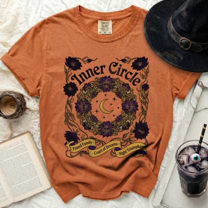 Orange t-shirt with "Inner Circle" and floral wreath design.