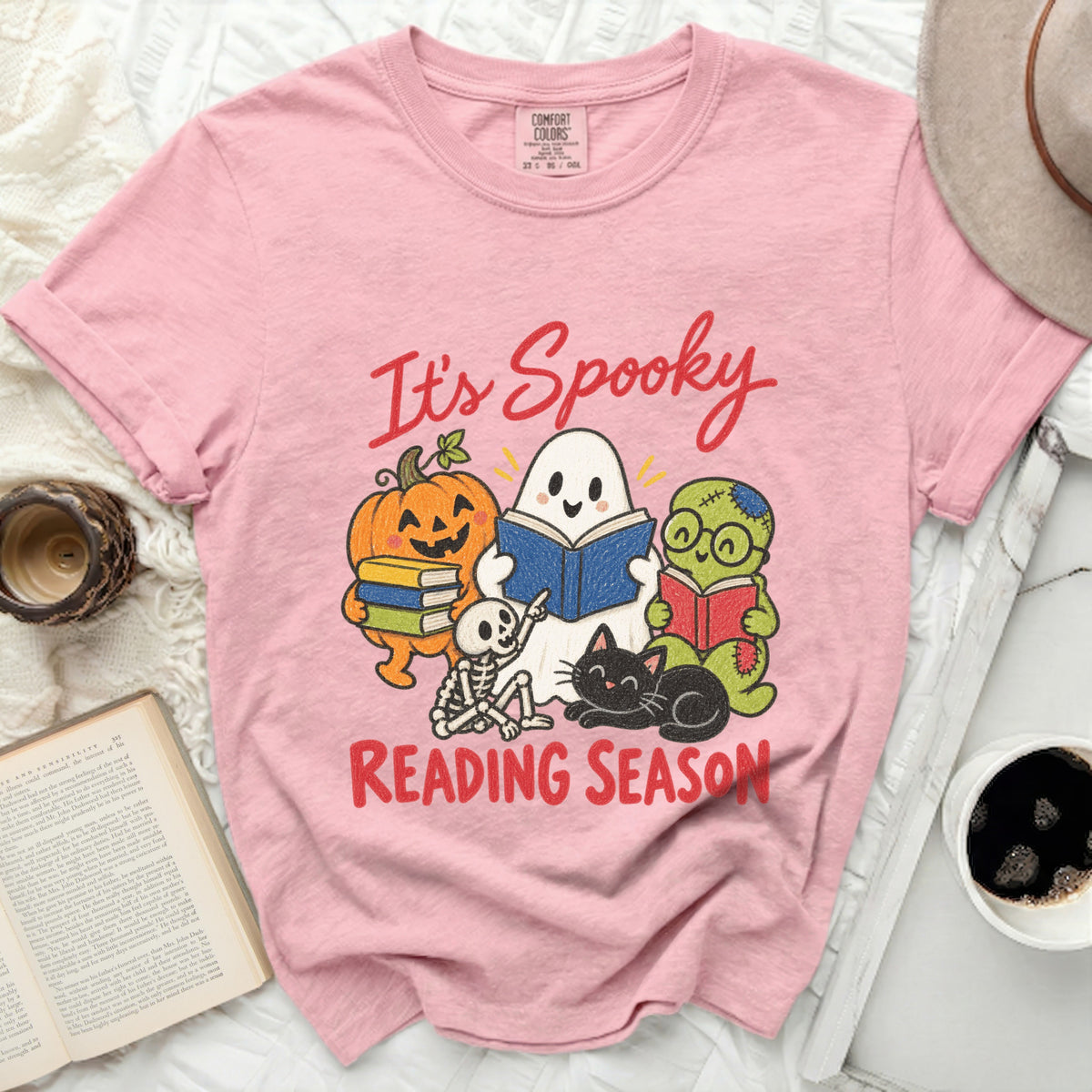 Pink t-shirt with ghost, pumpkin, skeleton, and zombie reading for "It's Spooky Reading Season".