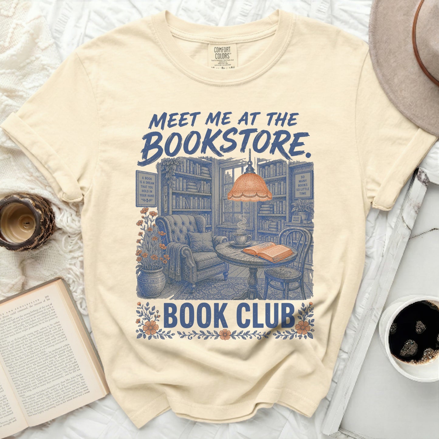 Cream t-shirt with "Meet Me at the Bookstore Book Club" graphic.