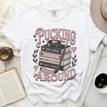 White t-shirt with "Pucking Around" and romance book genres graphic.