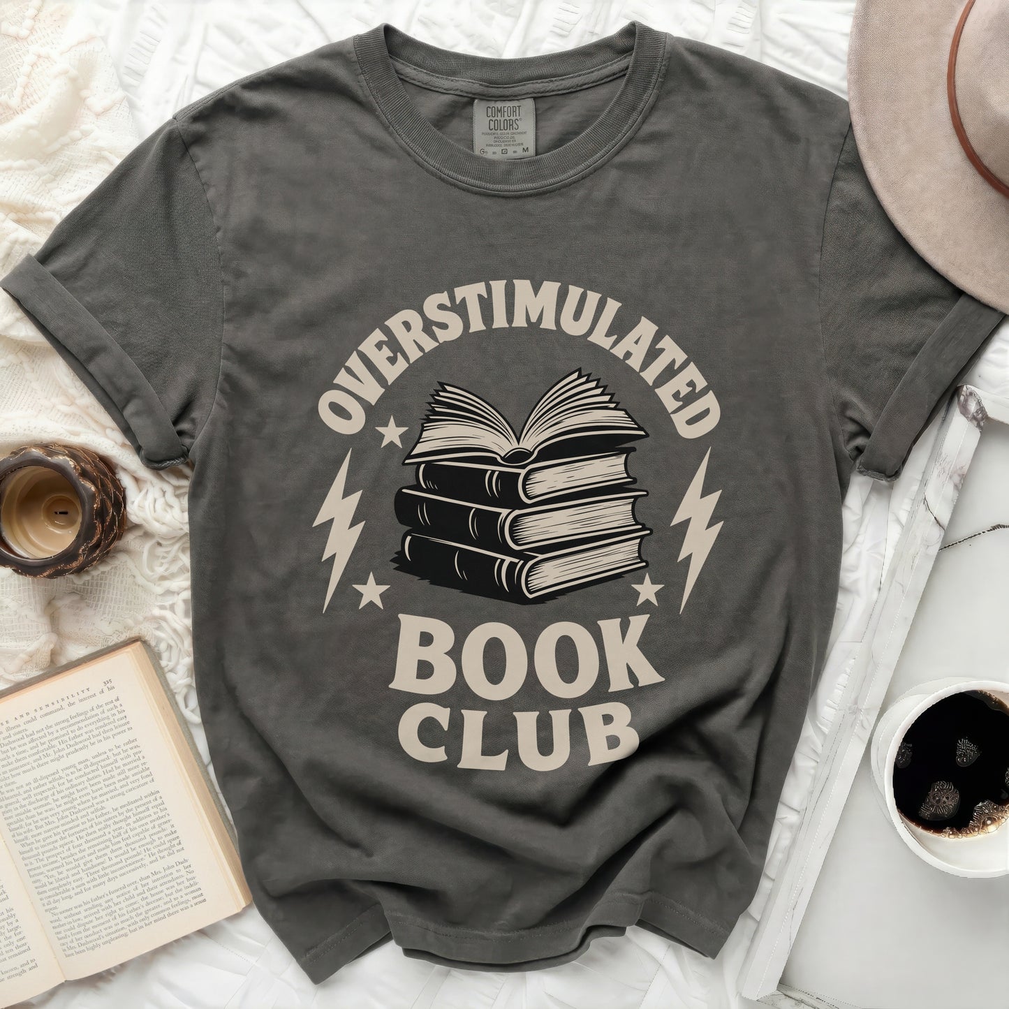 T-shirt with "Overstimulated Book Club" text and stack of books graphic.