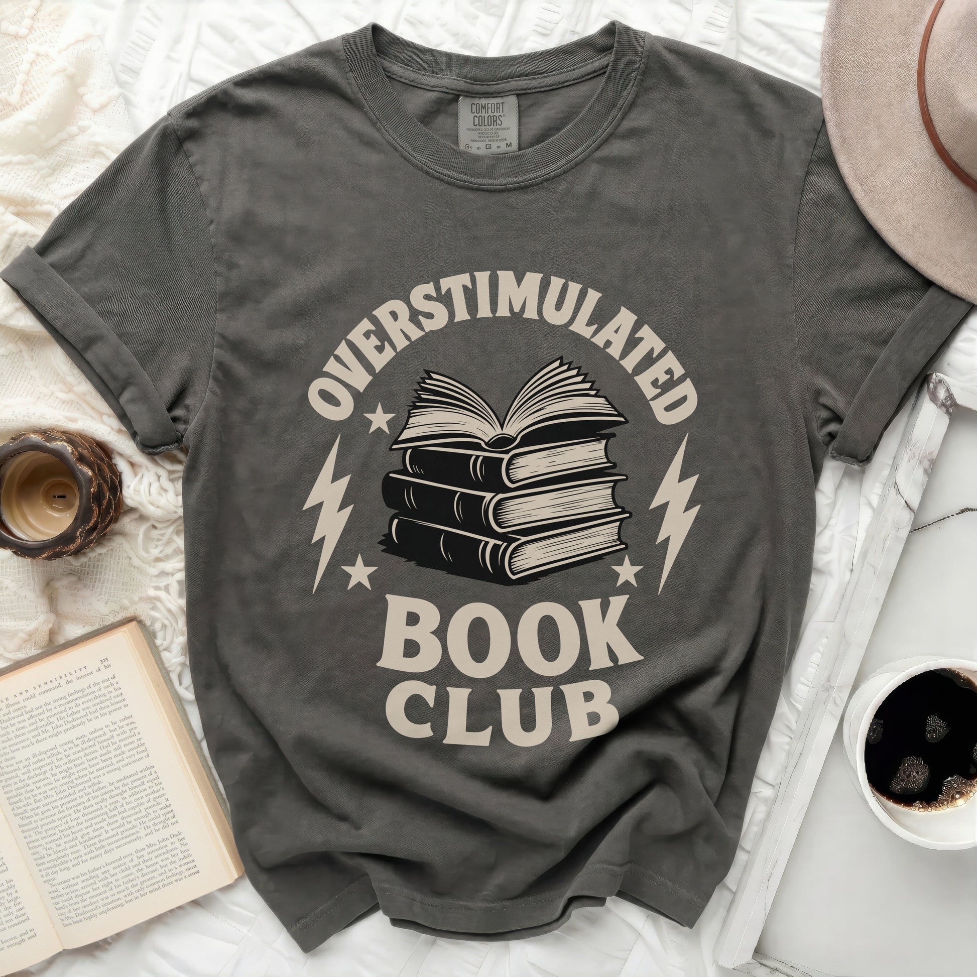 T-shirt with "Overstimulated Book Club" text and stack of books graphic.