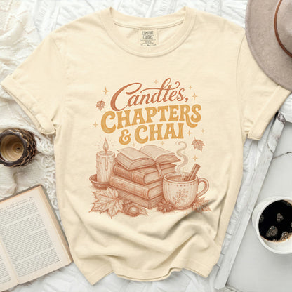 Cream t-shirt with vintage style graphic: Candles, Chapters & Chai.