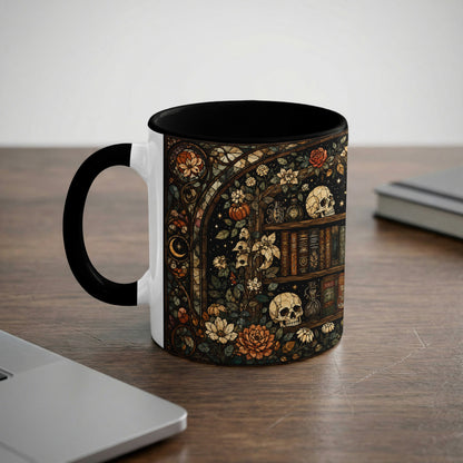 White mug with black interior and handle featuring a gothic floral bookshelf with skulls.