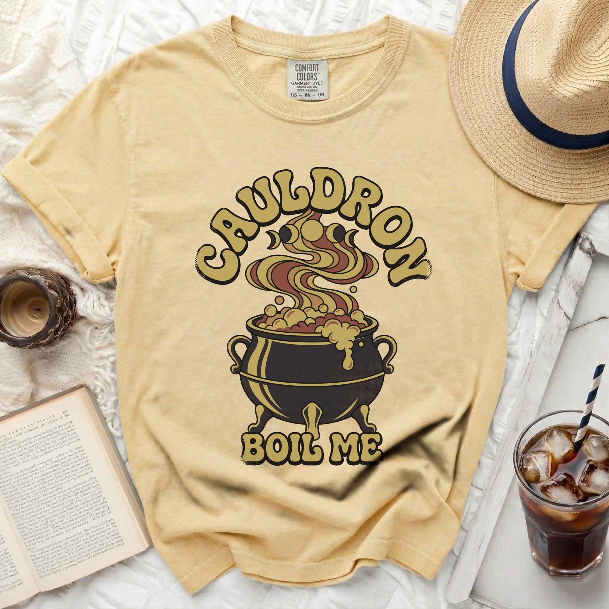 Yellow t-shirt with "Cauldron Boil Me" Halloween graphic and Comfort Colors tag.