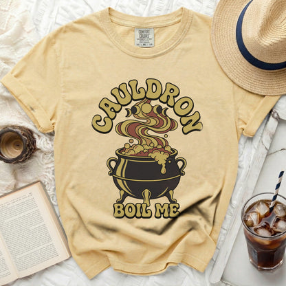Yellow t-shirt with "Cauldron Boil Me" Halloween graphic and Comfort Colors tag.