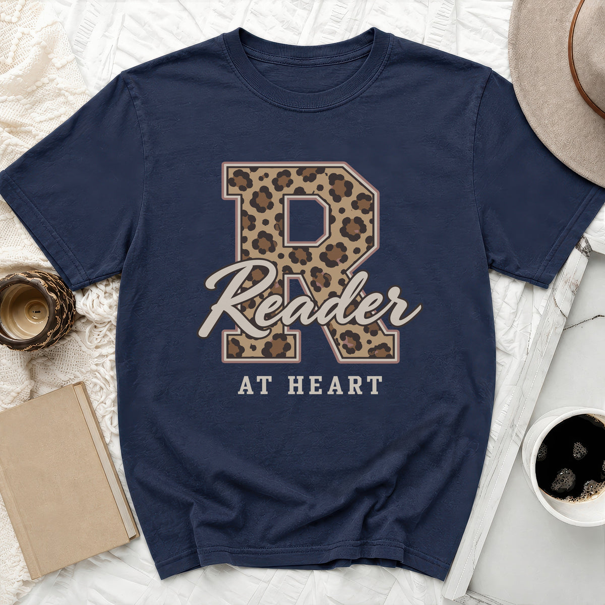 Navy t-shirt with leopard print R, "Reader AT HEART" text, and decorative elements.