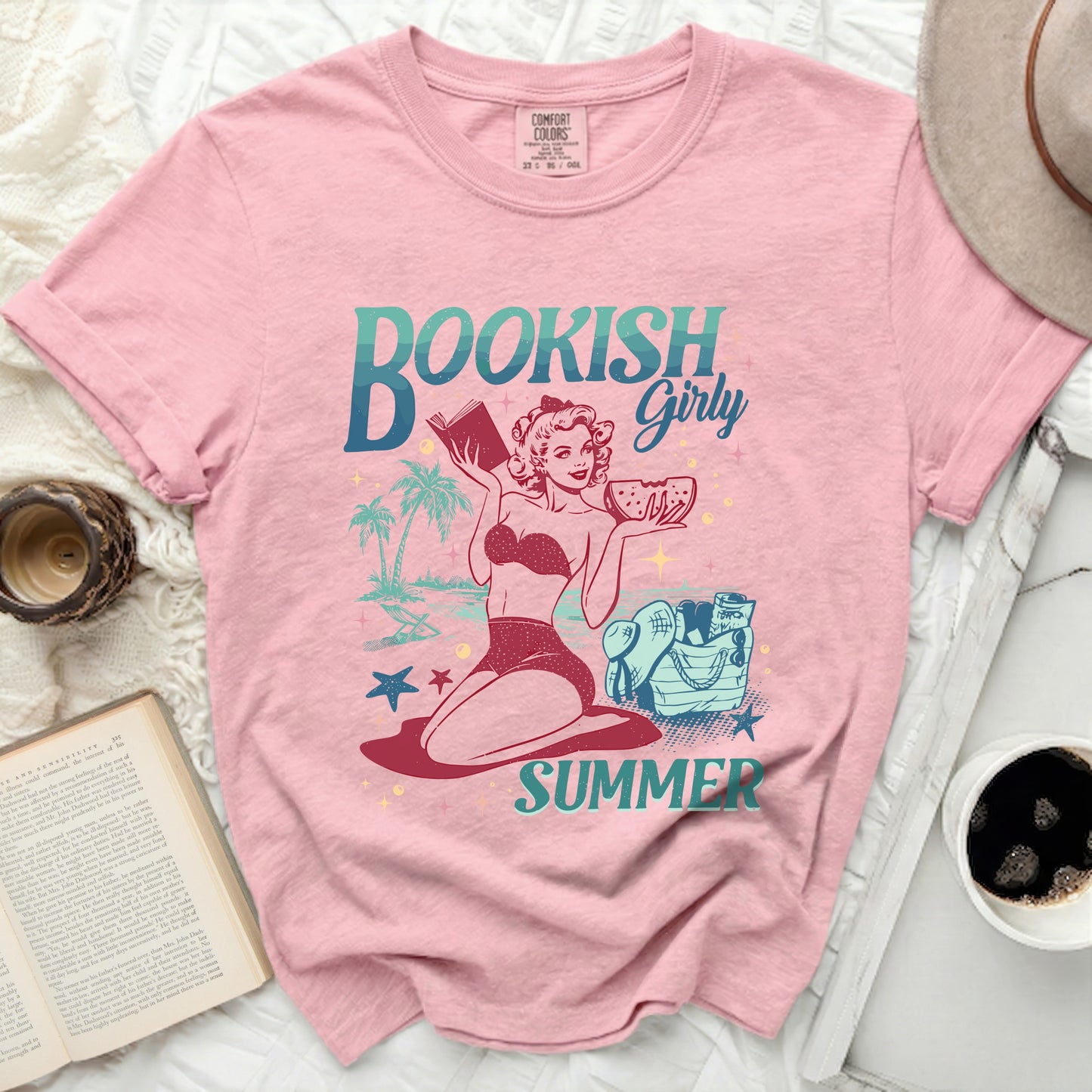 Pink t-shirt with "Bookish Girly Summer" graphic of a woman with books and watermelon.