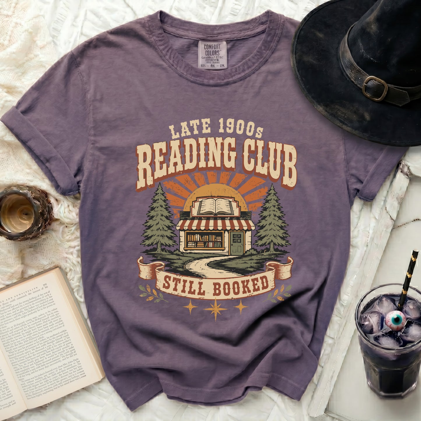 Vintage reading club graphic tee with book store and trees design.