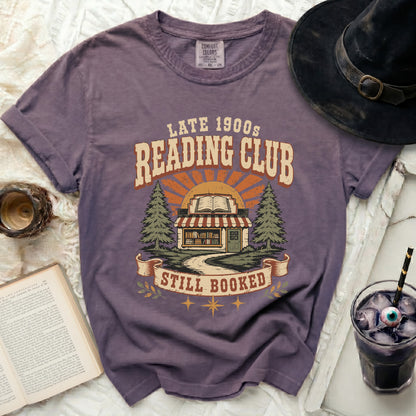 Vintage reading club graphic tee with book store and trees design.