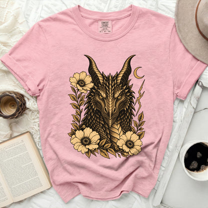 Pink t-shirt with gold dragon illustration, flowers, moon, and lightning bolt.
