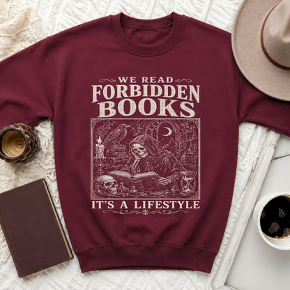Maroon sweatshirt with graphic text "We Read Forbidden Books" and skeleton reading a book.