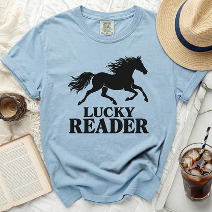 Light blue t-shirt with black silhouette of a running horse and text "LUCKY READER".