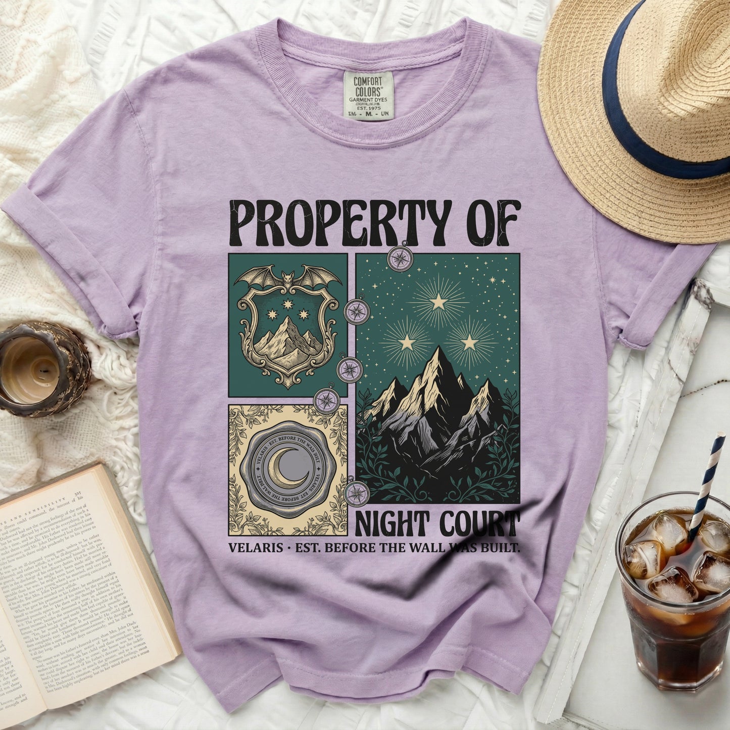 Purple t-shirt with "PROPERTY OF NIGHT COURT" text and celestial mountain graphics.