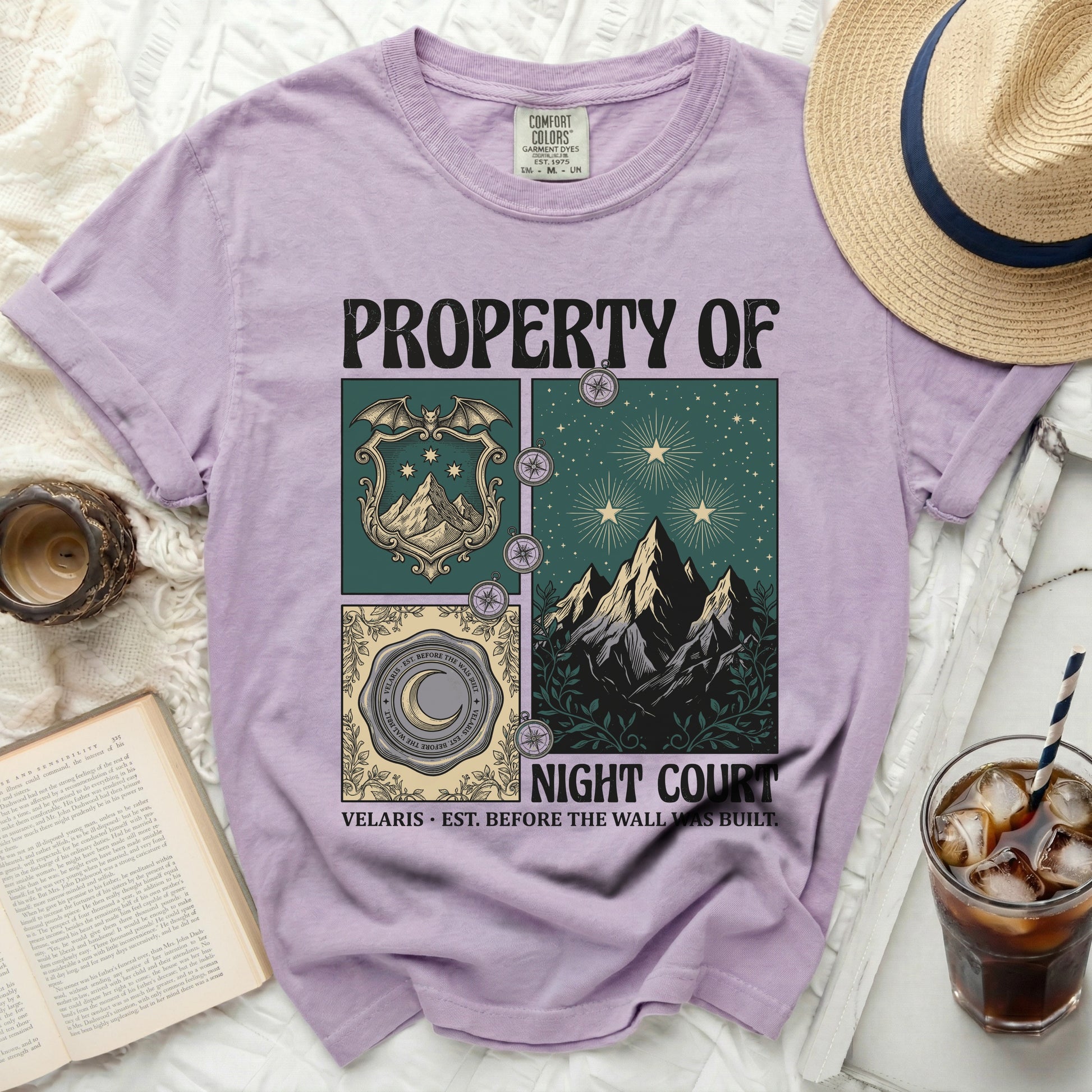 Purple t-shirt with "PROPERTY OF NIGHT COURT" text and celestial mountain graphics.