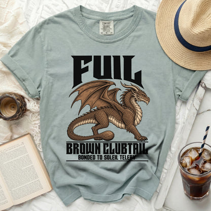 Light blue t-shirt with a brown dragon graphic and text "FUIL BROWN CLUBTAIL BONDED TO SOLEIL TELERY".
