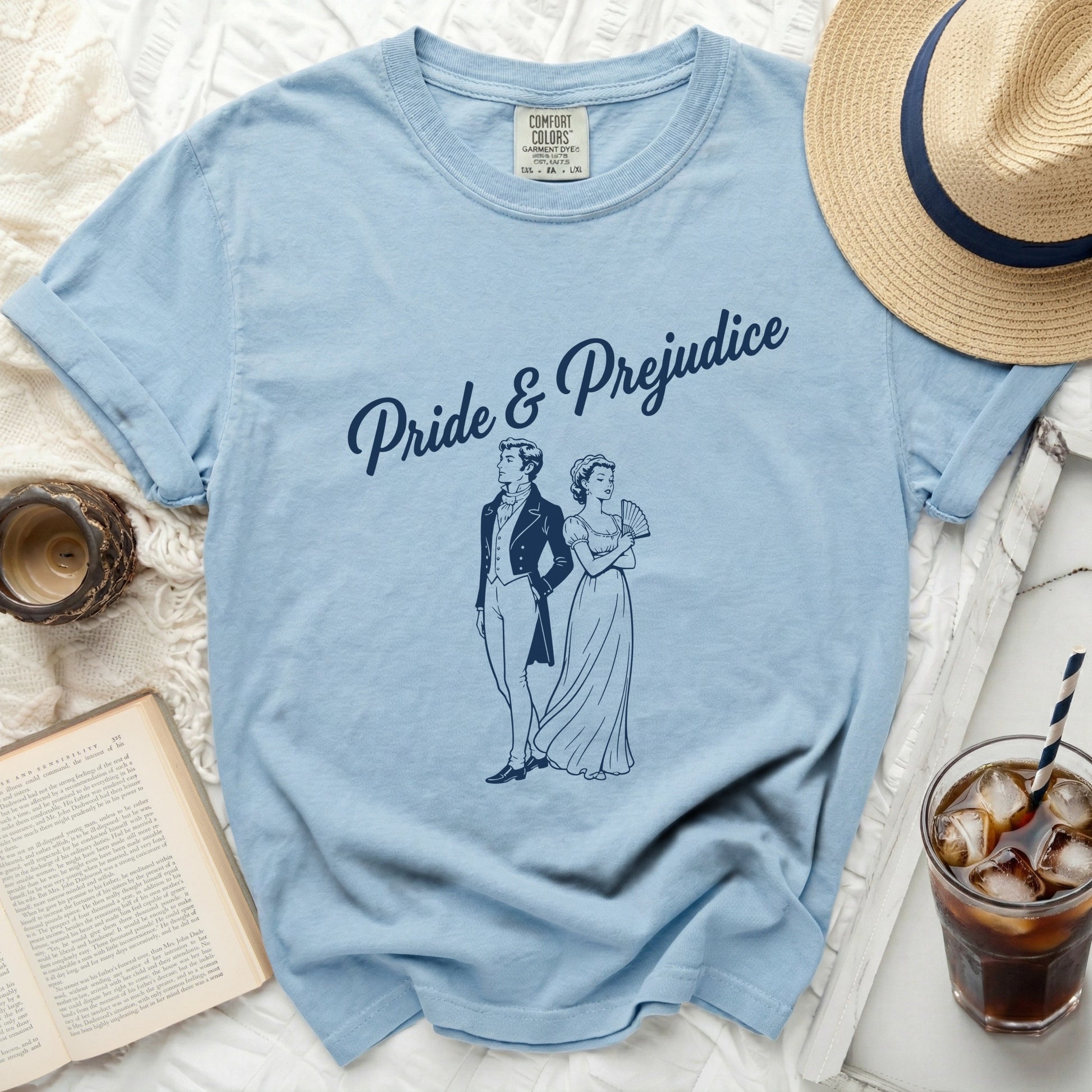 Light blue t-shirt with "Pride & Prejudice" and couple illustration.