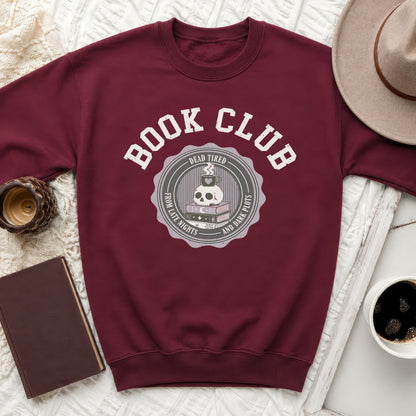 Maroon sweatshirt with "Book Club" and skull graphic.