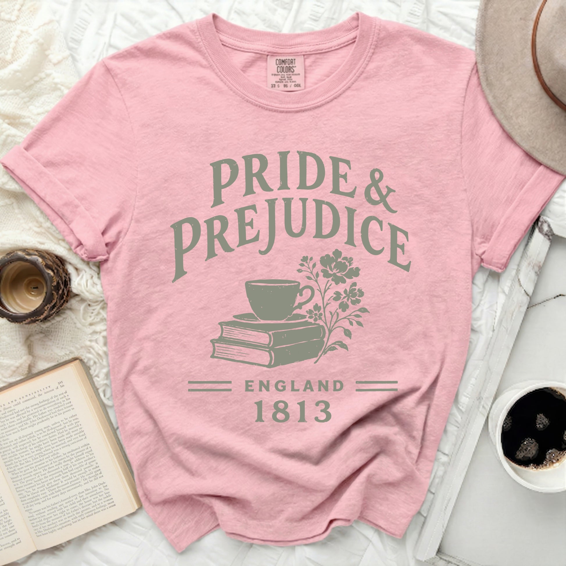 Pink t-shirt with "Pride & Prejudice England 1813" text and illustration.